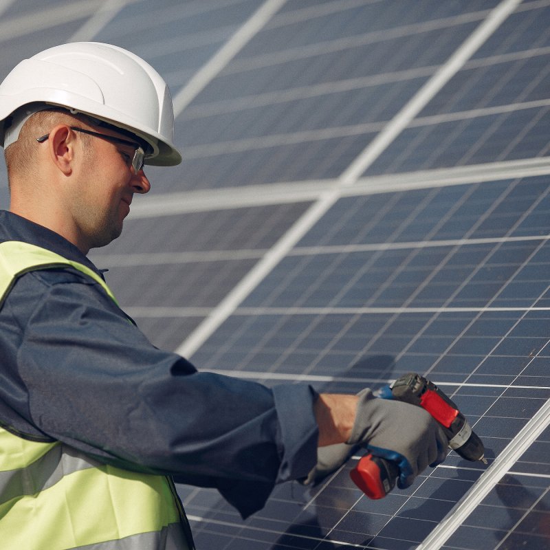 man-with-white-helmet-near-solar-panel 1